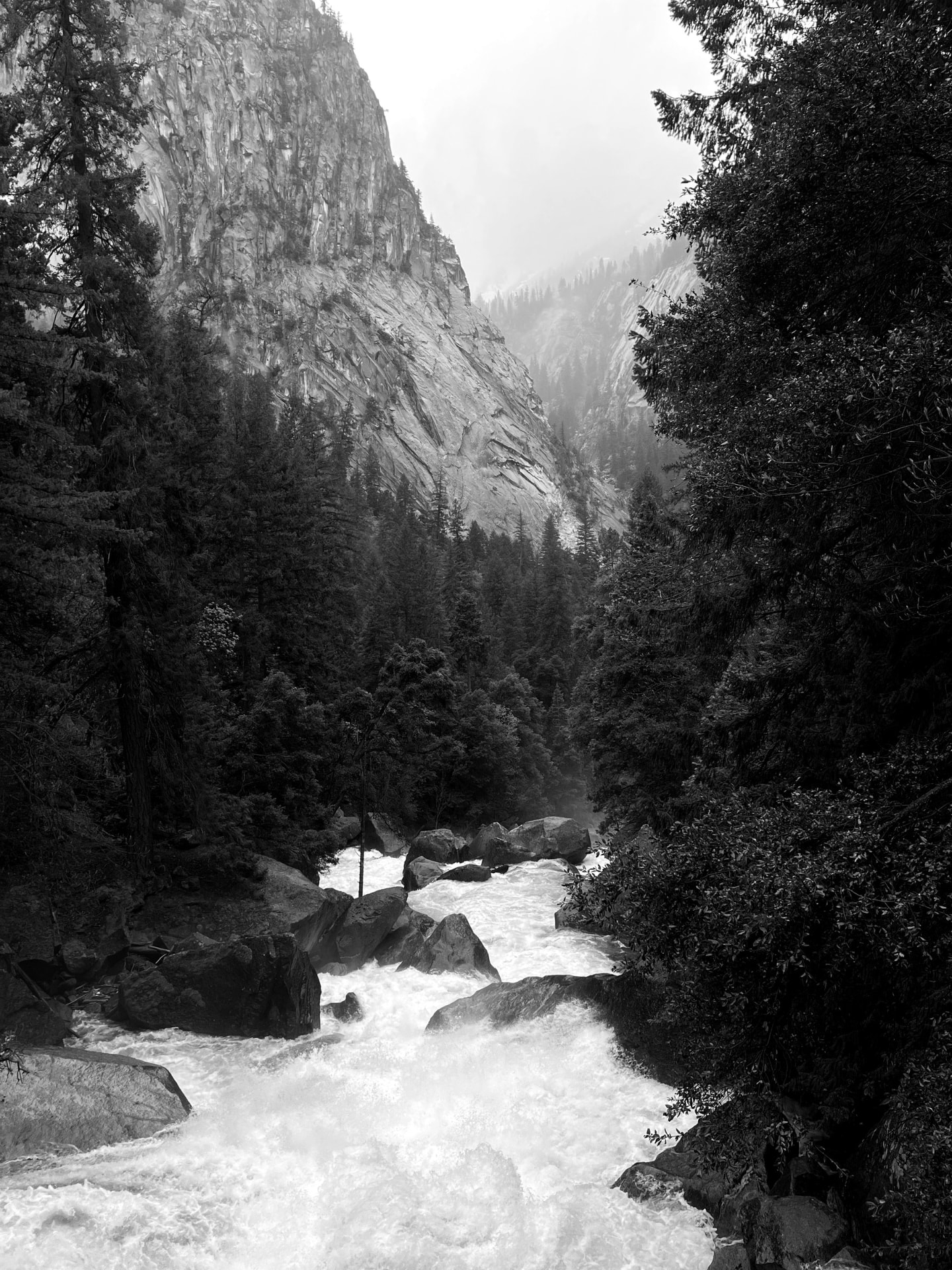 A river running through a granite canyon, in black and white